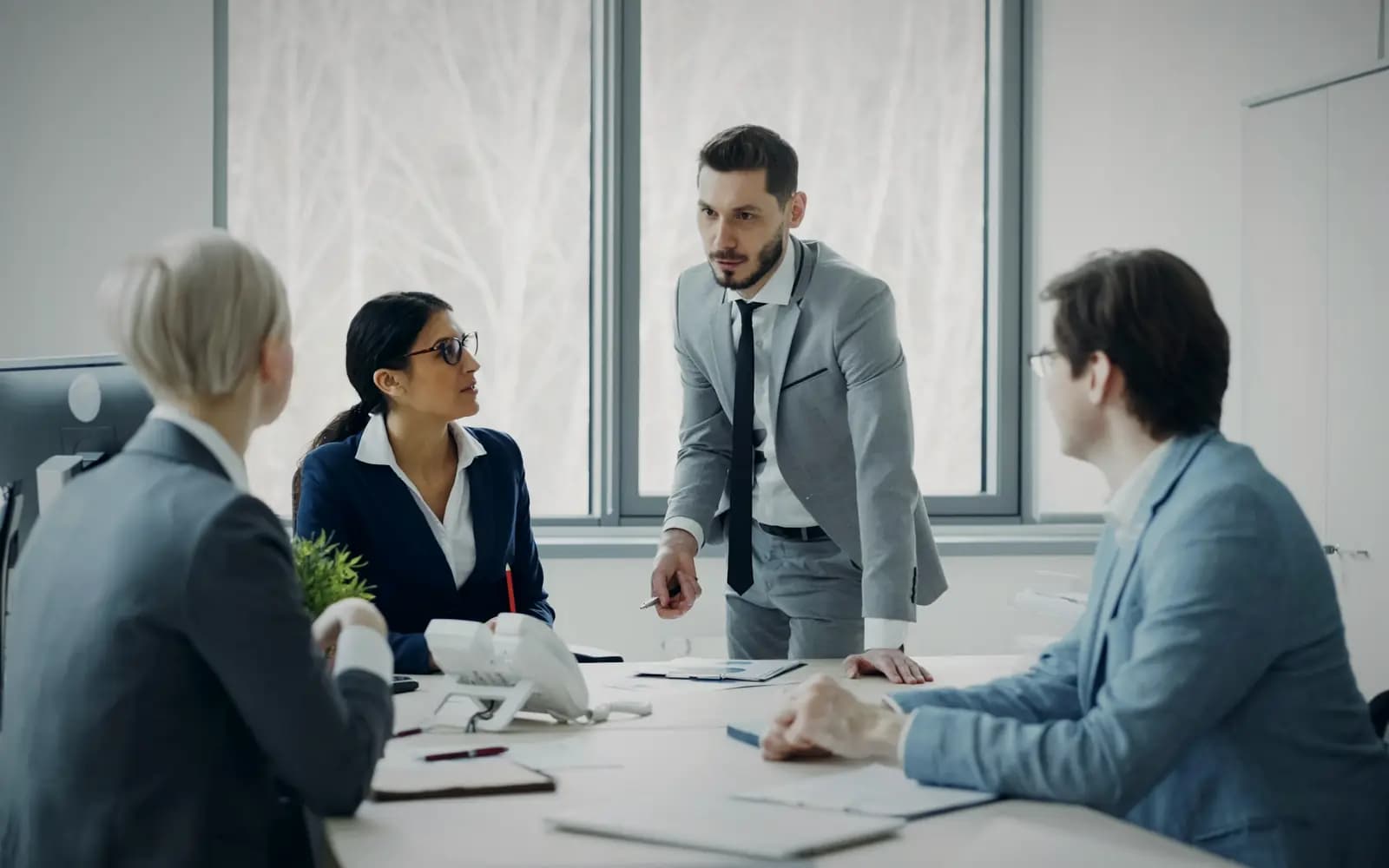 Finance professionals in a meeting around a conference table
