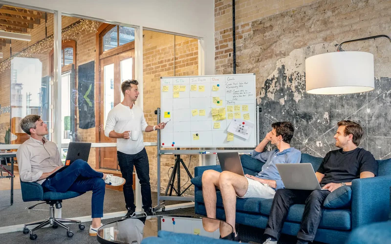 Consulting team reviewing a whiteboard plan in a modern office