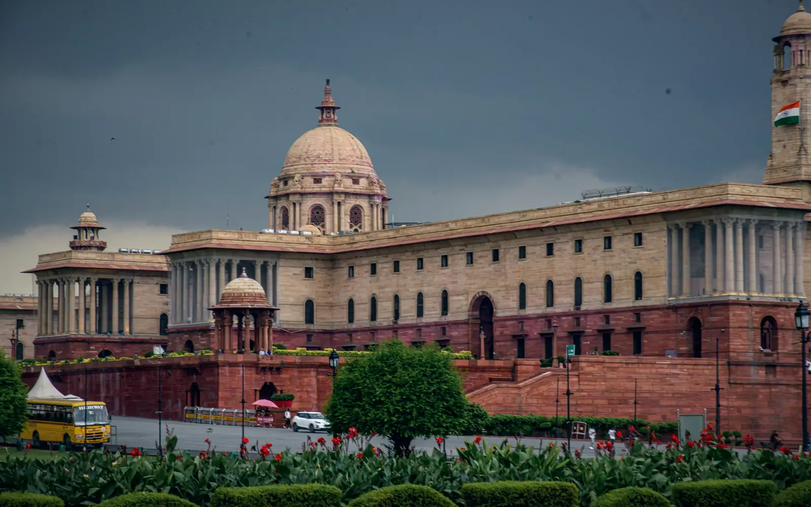 Sandstone government building with domes and gardens
