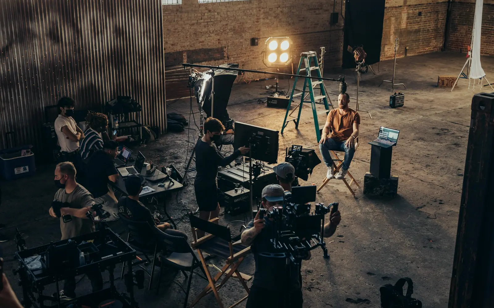 Film crew with cameras and lighting on a studio set