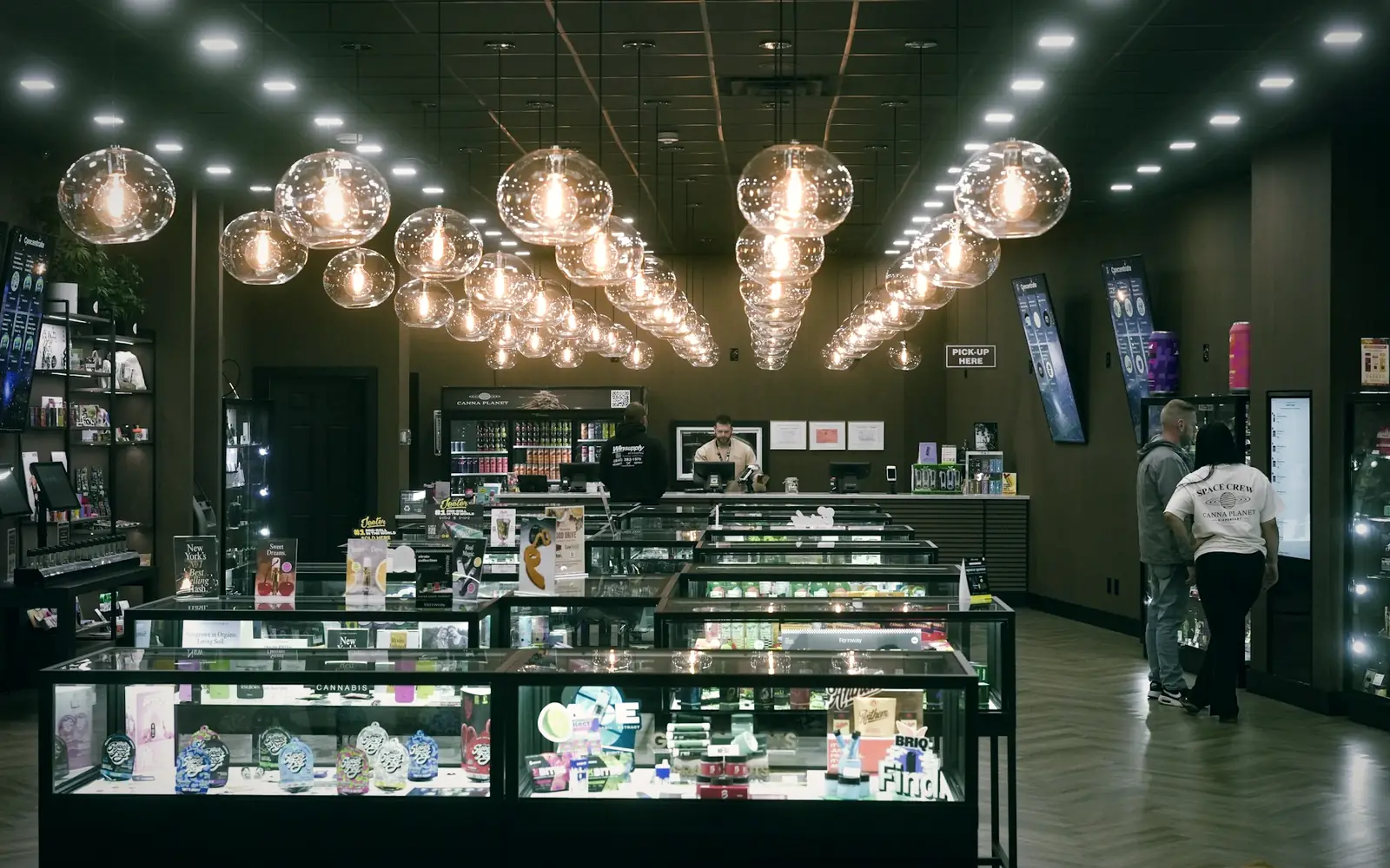 Modern retail store with lit display cases and pendant lights
