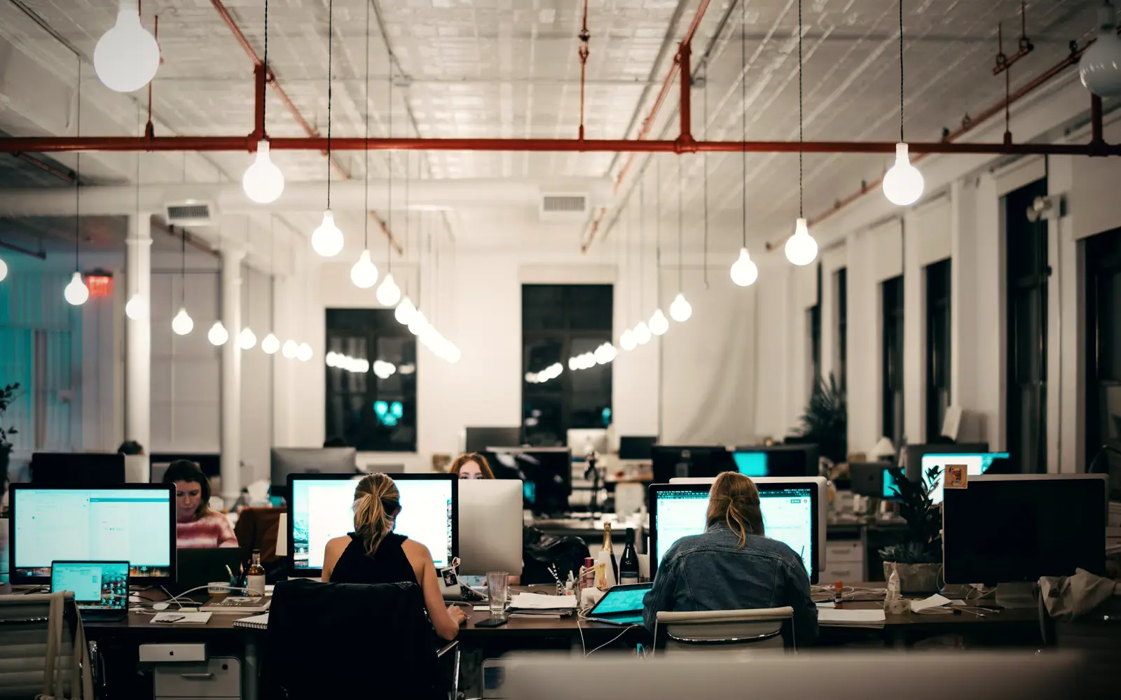 Team working at computers in a bright open-plan office