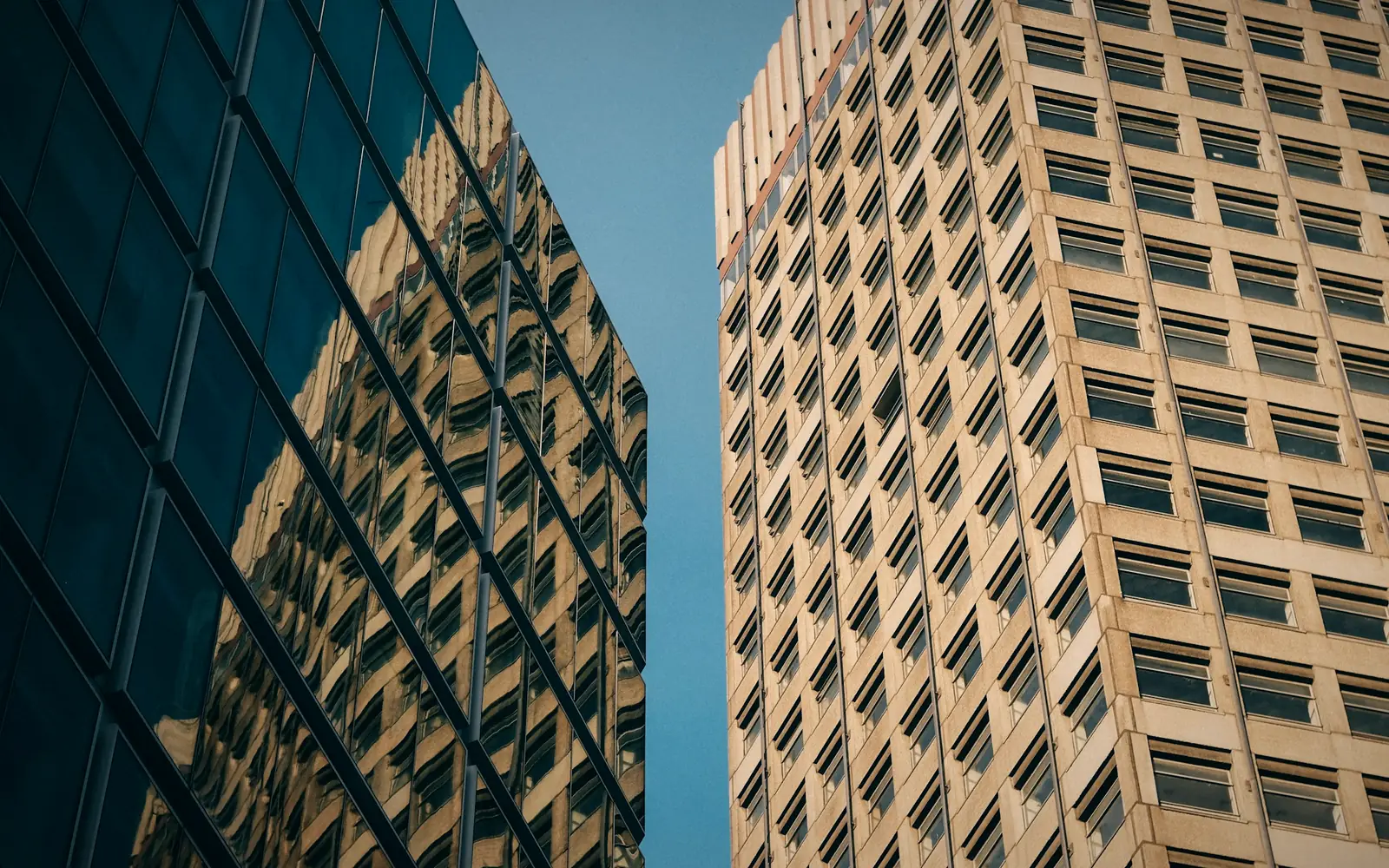 Two corporate office towers seen from street level